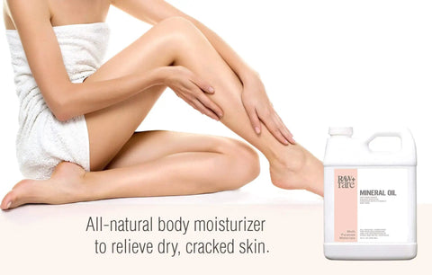 Food Grade Mineral Oil For Wood And Kitchen Surfaces 1 Gallon Vegan Formula Enriched With Vitamin E bottle next to a woman moisturizing her legs.