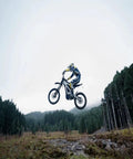 Adult Off Road Electric Dirt Bike Featuring A Badass 16800W Peak Motor And Massive 72V 50Ah Battery For Serious Torque Beast Mode Riding in mid-air jump.