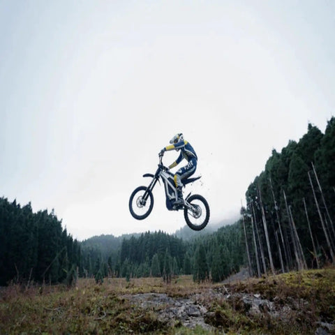 Adult Off Road Electric Dirt Bike Featuring A Badass 16800W Peak Motor And Massive 72V 50Ah Battery For Serious Torque Beast Mode Riding in mid-air jump.