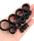 Hand displaying 26 Piece Silicone Ear Tunnels Set 8G To 1 Inch Hollow Flexible Soft Ear Stretching Kit for sleeping, sports, and daily wear.