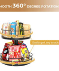 Two-Tier Lazy Susan Snack Organizer With Grab-and-Go Design, wood and metal trays holding snacks, 360-degree rotation in use