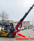 Dope Built Tough Forklift Jib Crane With Hydraulic Telescoping Boom Operating In Beast Mode For Max Lifting Performance As A True Warehouse Workhorse For Crushing Construction Loads Up To 12 Tons Daily, red and black crane attachment on a forklift.