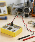 Multifunction Watch Pulse Tester Kit For Quartz Movement Accuracy Checks And Demagnetizing on workbench with watch parts