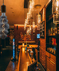 Beehive Style 4W Dimmable LED Edison Bulb With Oversized Spiral Filament in a vintage bar setting