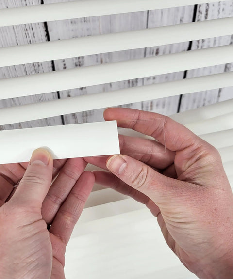 Easy DIY Slick Fix For Cracked Horizontal Blinds Clear Mini Slat Repair Kit With String Holes And Solid Tabs, hands holding repair tab.