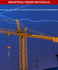 Side view of a yellow tower crane with hanging hook against a blue sky with lightning.