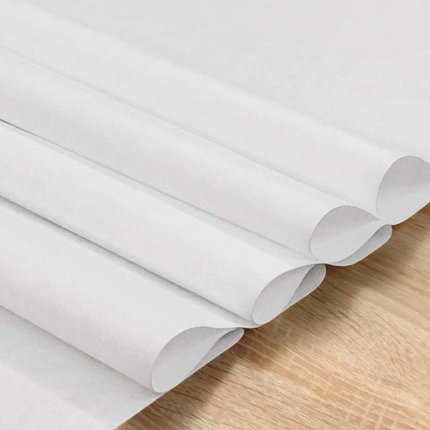 Folded white Merv 16 Polypropylene Filter Material with Electrostatic Charge for DIY mask inserts, 24" W x 180" L, on wooden surface.