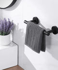 Matte Black Towel Bar 36 Inch Stainless Steel SUS304 Wall Mount Rustproof Bathroom Shower Towel Rack Holder Screw Mounted With Stainless Anchors Built To Last Heavy Duty 11 Lbs Load Capacity with grey towel in bathroom setting.