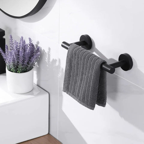 Matte Black Towel Bar 36 Inch Stainless Steel SUS304 Wall Mount Rustproof Bathroom Shower Towel Rack Holder Screw Mounted With Stainless Anchors Built To Last Heavy Duty 11 Lbs Load Capacity with grey towel in bathroom setting.