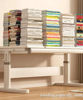 Dope Heavy Duty Manual Adjustable Standing Desk With Smooth Crank Raise And Practical Drawer Next To Perforated Pegboard loaded with books.