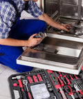 Person using 226 Piece Home And Auto Repair Tool Kit With Sturdy Toolbox For DIY Enthusiasts, Homeowners, And Handymen, Includes High Quality Steel Tools, ANSI Standards, And All Essentials For Everyday Fixes near dishwasher