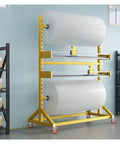 Heavy Duty Packing Station With Upgraded Cutter And Steel Bubble Roll Dispenser Stand mobile shipping prep cart showcasing bubble wrap rolls on a yellow rack.