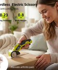 Heavy Duty Cordless Electric Cutter With 4V Rechargeable Battery And Two Sharpened Rotary Blades in use cutting a cardboard box.