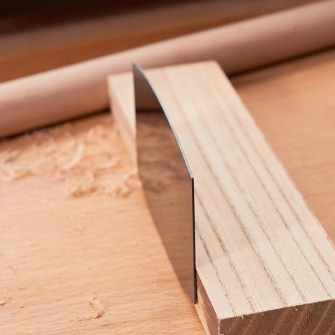 Top Shelf Six Piece Cabinet Scraper And Burnisher Kit With Blue Spring Steel Blades Plus Hardened High Speed Steel Sharpening Rod For Knockout Woodworking Finishes Daily showing a blue spring steel blade on wood.