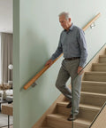 Heavy Duty Beech Wood Stair Handrail 100 Cm Super Grippy Round Safety Grab Bar used by man descending stairs.