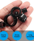 Hand holding various sizes of black nylon cable snap grommets from the 170 Pcs Black Round Nylon Cable Snap Grommets Set Durable PA66 Material