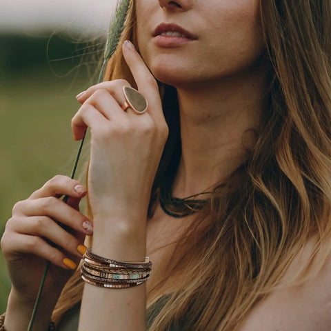 Totally Fire Leather Wrap Bracelet For Women Featuring Super Comfy Braided Leather Straps And Mixed Brown Beads With A Boho Western Layered Cuff Look That Gets Compliments Every Single Day worn by a woman outdoors.