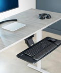 Smooth Gliding Under Desk Keyboard And Mouse Tray With Plush Foam Padding For Home Office Ergonomic Workstation Setup adjustable height shown under a desk.