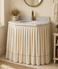 Peel And Stick Under Sink Skirt Cover In Crisp White Pleated Cotton conceals pipes under a marble sink with elegant pleats.
