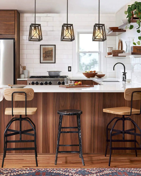 Farmhouse Pendant Light With Industrial Metal Wire Cage In Oil Rubbed Bronze hanging over kitchen island with stools