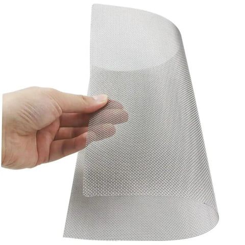 Holding a sheet from the Four Piece Bumper Repair Mesh Screen Kit For Vehicles Durable Fine Mesh Easy Application Quick Damage Restoration Automotive Accessory Great For Patching Holes Dings And Curb Damage.