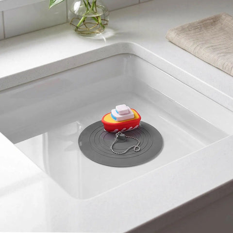 TEHAUX Silicone Bathtub Drain Stopper 6'', Hair Catcher for Bathroom with boat design in white sink.