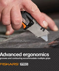 Pro Retractable Folding Utility Knife With CarbonMax Blade, Dual Lock Safety cutting material, close-up view