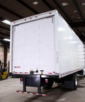 Rear view of a box truck in a garage, showcasing door area suitable for Beefed Up 1 Inch Steel Truck Door Roller 50 Pack With Durable 608ZZ Bearing