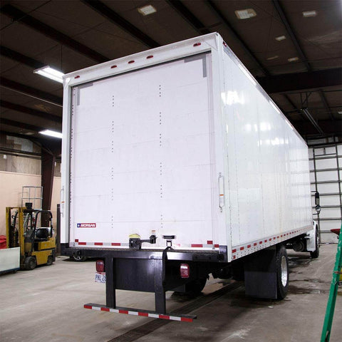 Rear view of a box truck in a garage, showcasing door area suitable for Beefed Up 1 Inch Steel Truck Door Roller 50 Pack With Durable 608ZZ Bearing