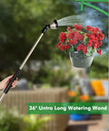 RESTMO 36-inch metal watering wand with 180° swivel head and black grip watering a hanging red geranium pot