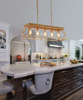 Five Light Gold Modern Farmhouse Chandelier For Kitchen Island over marble countertop in luxurious kitchen setting