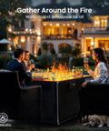 Gathering around 43 Inch Rectangular Propane Fire Pit Table With 60,000 BTU Heat for Backyard Hangouts, warm setting, night view