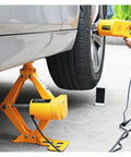 No Sweat Electric Trailer Jack With Wireless Remote, Portable 2.5 Ton Car Lifter in use under vehicle for tire change.
