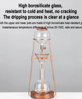Polished Glass Cold Brew Coffee Maker Featuring Precise Drip Valve And Rugged Stainless Steel Base Serving Straight Up Smooth Iced Teas With Zero Fuss At Kitchen Bars, showcasing borosilicate glass and wood base.
