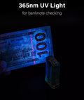 Angel Eyes E8 Keychain Flashlight 700 Lumens USB C Rechargeable showing 365nm UV light on banknote in dark