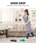 Long Handle Broom With Dense Stiff Bristles Heavy Duty Floor Sweeper Built For Yards Driveways Garages Low Bend Build, in use on hardwood floor.