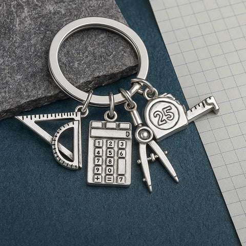 Engineer Keychain Set With Geometry Charm And Measuring Tools, featuring mini triangle ruler, calculator, compass, and tape in gunmetal.