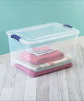 Heavy Duty SixtySix Quart Clear Plastic Storage Bins Two Pack With Blue Latch Lids Stackable Organizers For Bulky Seasonal Apparel And Sports Gear Easy Stash with folded blankets inside.