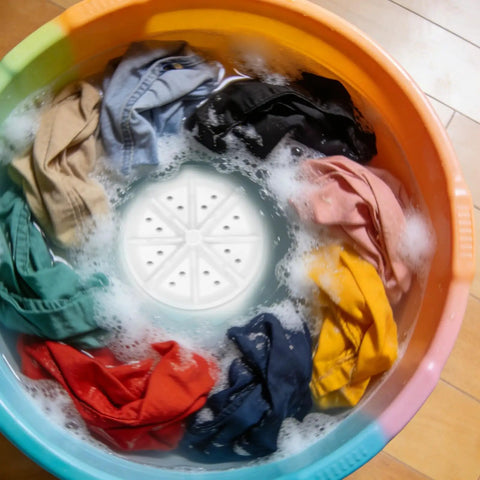 This Slick Mini Turbine Washing Machine Is Your New Usb Powered Portable Laundry Companion Built For Rv Trips and Delicate Loads Made From Rugged Plastic To Handle Everyday Grime And Get Things Done Fast Without Breaking A Sweat, with colorful clothes in water.