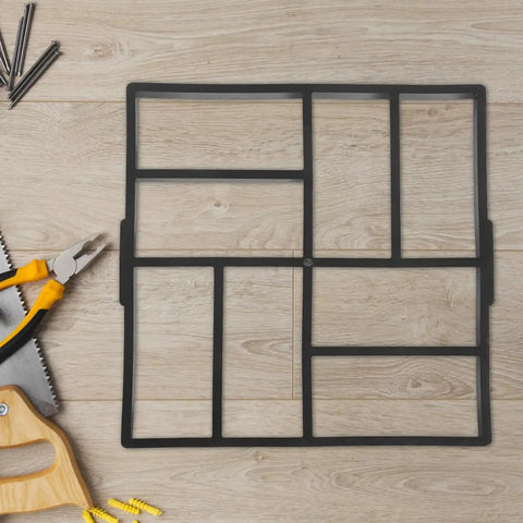 Plastic Path Maker Mold For Concrete Pavers 16.45 Inch shown on wooden floor with tools.