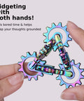 Hand holding Quiet Metal Infinity Gear Fidget Toy For Focus And Stress Relief with rainbow-plated smooth gear movement