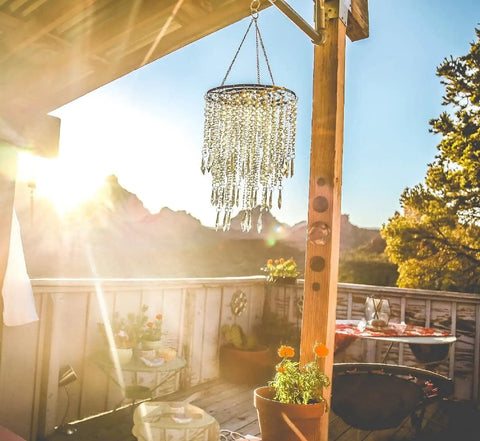 Beaded Acrylic Chandelier Pendant Light With Gold Frame 3 Tier Hanging Lampshade in outdoor setting at sunset