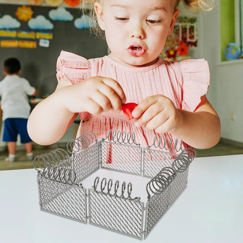 Child playing with Slick Light Gray Plastic Miniature Fence Kit With Dead Simple Snap Together Design For Farm Diorama And Prison Model Builds.