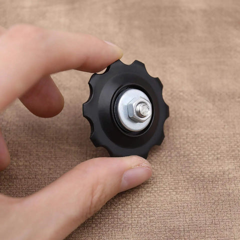 Hand holding 4X 10T Bicycle Gear Mech Pulley Jockey Wheel Kit Universal For 5,6,7,8 Speed Derailleur With Dust Cover, Bolt