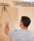 Man using Heavy Duty Paint Roller Kit With Long Extension Pole And Six Stainless Rods Two Nine Inch Replacement Covers For Zero Sweat Wall And Ceiling Painting.