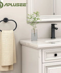 Killer Matte Black Oval Towel Ring Features Smooth Swivel Action Wall Mounted Bathroom Accessory with towel on it.