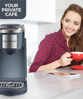 One Touch Single Cup Coffee Brewer With Quick Brew, 12 Oz Grey Coffee Maker, in kitchen setting with user nearby