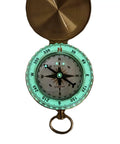 Glow In The Dark Brass Pocket Compass For Kids, Waterproof Navigation Tool with luminous dial open showing directions.