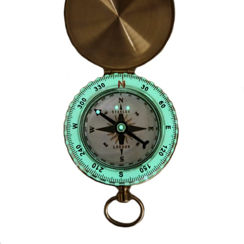 Glow In The Dark Brass Pocket Compass For Kids, Waterproof Navigation Tool with luminous dial open showing directions.