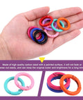 Hand holding 32Pcs 8 Colors 25mm 1 Inch Round Spring O Rings Assortment Kit With Carbon Steel Buckles Snap Hooks Keyring Rings